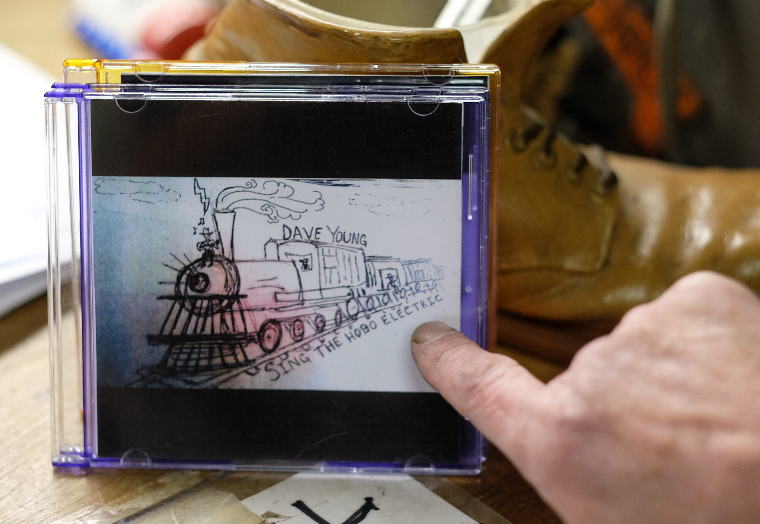 David Young of Graham's Shoe Service talks about one of his music cd's, Wednesday Nov. 23, 2016. (Photo by Norm Shafer).