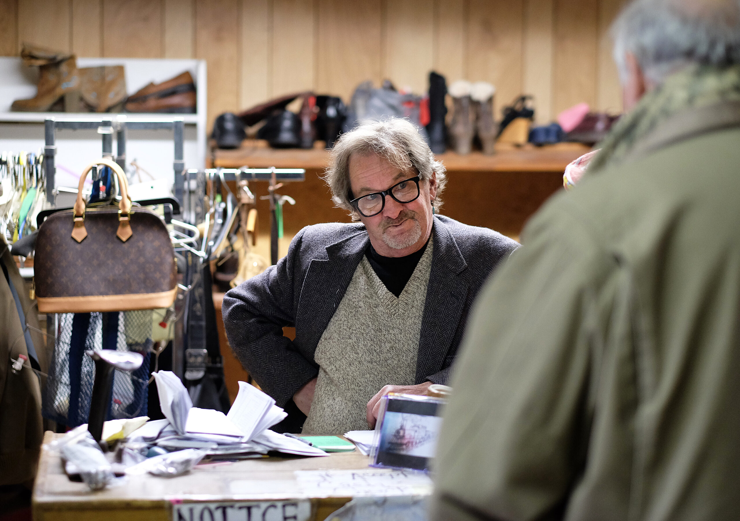 David Young talks with a customer in his shoe repair shop, Wednesday Nov. 23, 2016. (Photo by Norm Shafer).